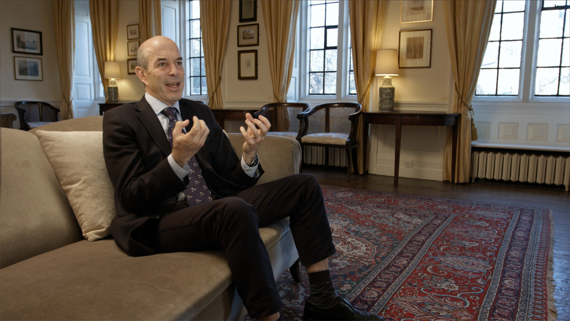 Ian Goldin Disparity Film Still, Ian Goldin on sofa