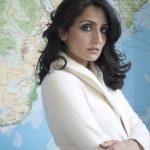 Renu Mehta in front of map